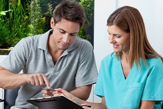 A man filling out paperwork at the dentist