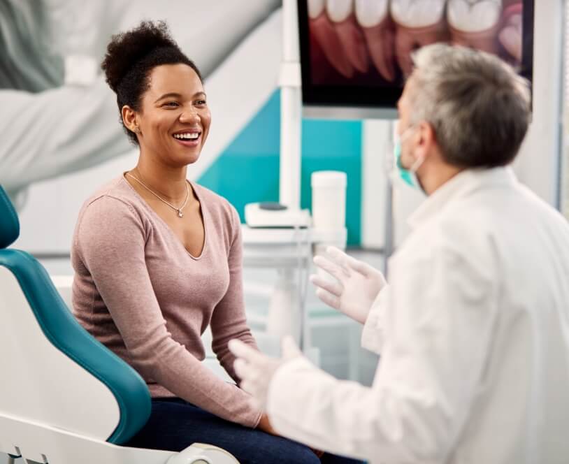 Smiling woman talking to dentist