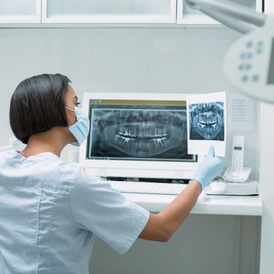 Dentist looking at all digital dental x-rays
