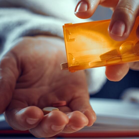 Dental patient holding antibiotic therapy pills