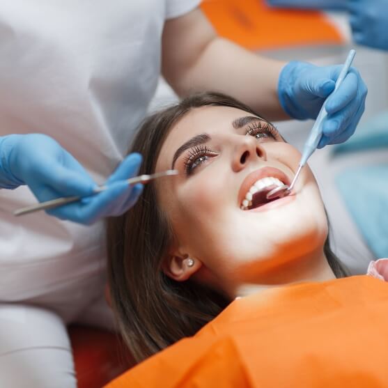 Woman receiving oral cancer screening