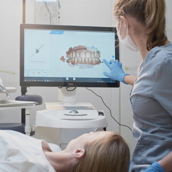 Dentist scanning a patient’s smile with dental technology