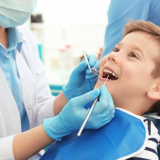 Child receiving dental checkup and teeth cleaning