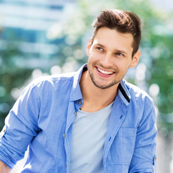 Man smiling after getting tooth-colored fillings in Derby, KS