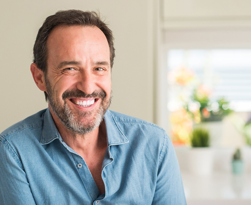 man smiling with dental crowns in Derby