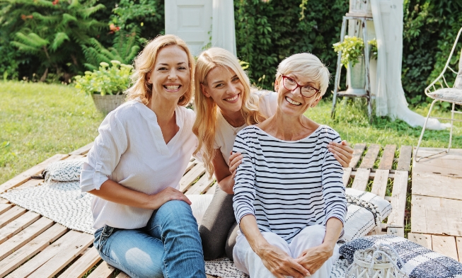 Three women smiling after emergency dentistry visit