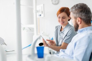 A dentist explaining implant treatment to a patient