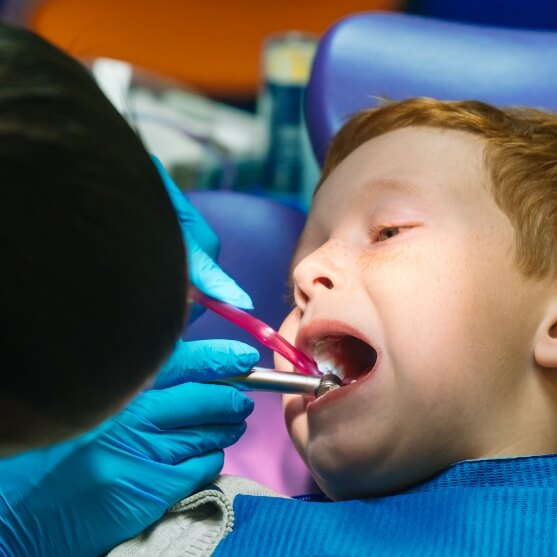 Child receiving dental treatment