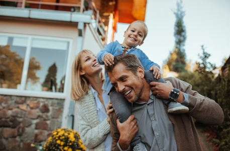 Parents and child smiling after visiting their family dentist