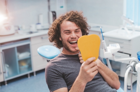 Man smiling after customized dental care