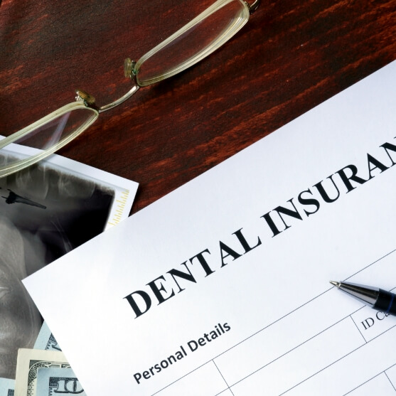 Dental patient completing paper dental insurance forms
