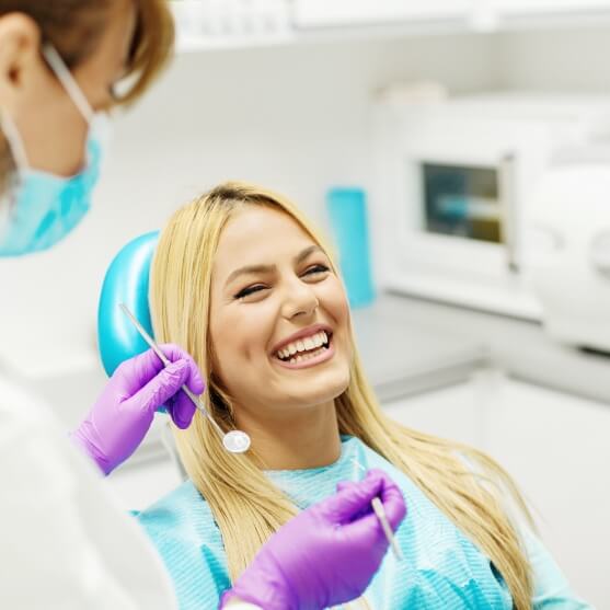 Woman laughing with dentist in dental office