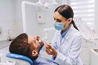Dentist examining patient's teeth