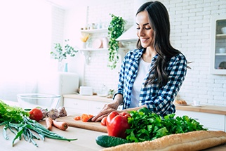 Woman preparing vegetables in kitchen
