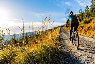 Person riding bike on mountain trail
