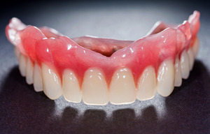 Full dentures on a grey surface