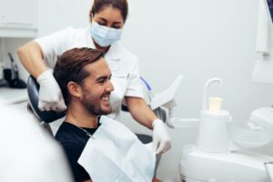 Happy dental patient preparing for root canal treatment 